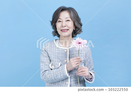 active young senior Korean Asian woman holding flowers active young senior Korean Asian woman holding flowers 103222550