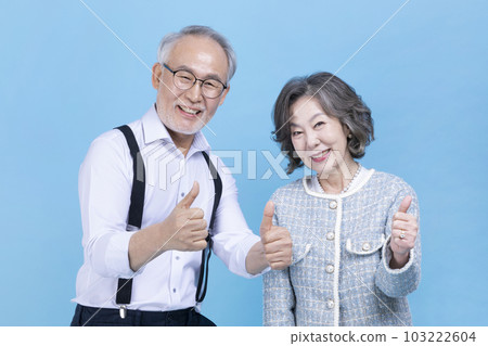 active young senior Korean Asian couple with hand motion active young senior Korean Asian couple with hand motion 103222604