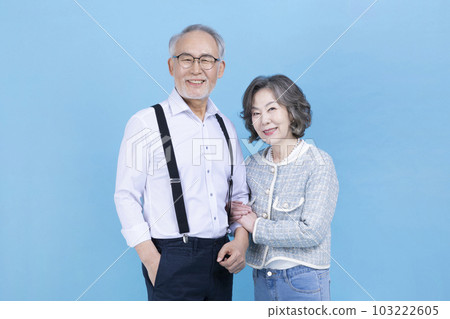 active young senior Korean Asian man and woman standing with arms crossed 103222605