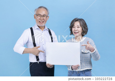 active young senior Korean Asian couple with copyspace board 103222728