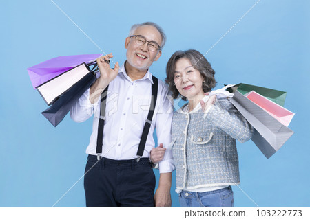 active young senior Korean Asian couple holding shopping bags active young senior Korean Asian couple holding shopping bags 103222773