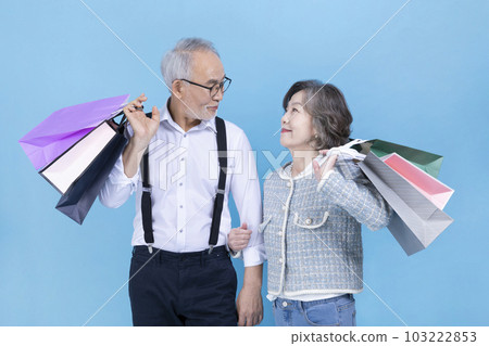 active young senior Korean Asian couple holding shopping bags active young senior Korean Asian couple holding shopping bags 103222853