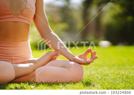 Young woman doing excercise at the public park. Fitness woman doing yoga exercises in the morning. 103224808