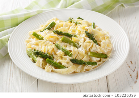 Asparagus Pasta with Lemon zest and Parmesan closeup on the plate. Horizontal 103226359