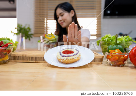Woman rejecting junk food. Woman rejecting junk food. 103226706