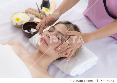 Young Asian Woman enjoying and relax massage in spa salon, Spa beauty massage healthy wellness , Lifestyle Healthy Concept. Young Asian Woman enjoying and relax massage in spa salon, Spa beauty massage healthy wellness , Lifestyle Healthy Concept. 103227025