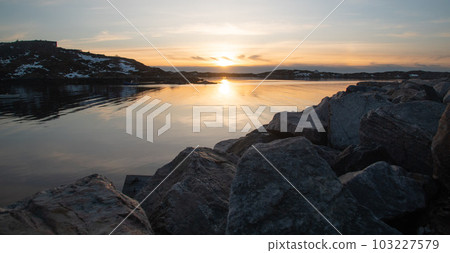 Fabulous sunset over the rocky shore of the North Sea in Norway Fabulous sunset over the rocky shore of the North Sea in Norway 103227579
