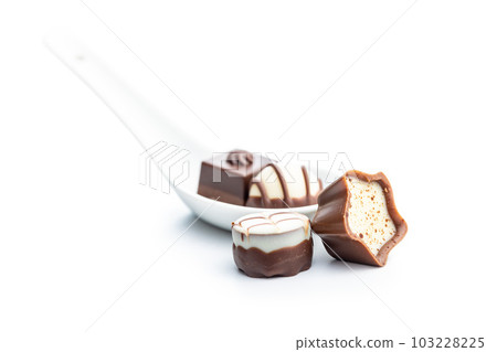 Sweet chocolate pralines.  Tasty chocolate truffles isolated on white background. 103228225