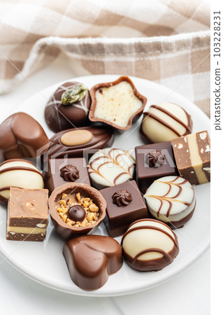 Sweet chocolate pralines. Tasty chocolate truffles on plate. Sweet chocolate pralines. Tasty chocolate truffles on plate. 103228231