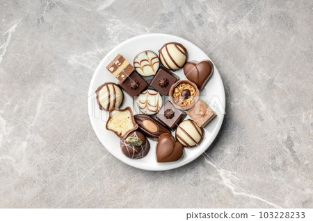 Sweet chocolate pralines.  Tasty chocolate truffles on plate. Top view. 103228233