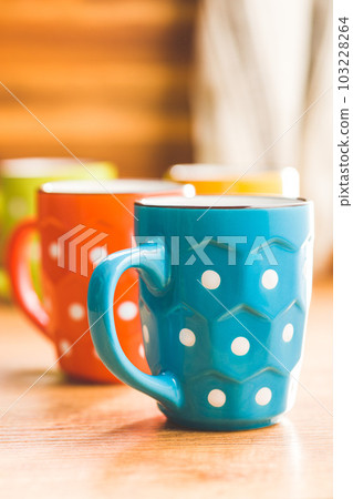 The polka dot mugs on kitchen table. The polka dot mugs on kitchen table. 103228264