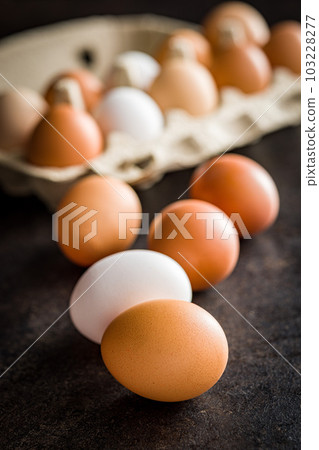 Whole chicken eggs on black table. Whole chicken eggs on black table. 103228277