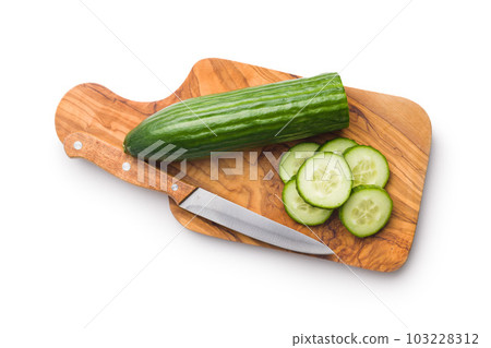 Sliced fresh green cucumber on cutting board isolated on white background. Sliced fresh green cucumber on cutting board isolated on white background. 103228312