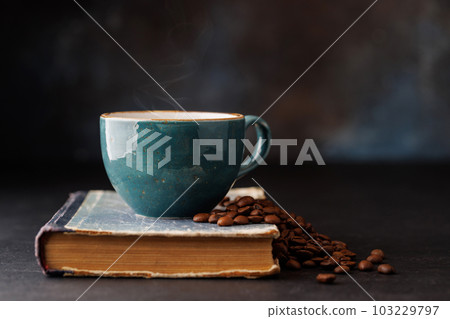 Rich coffee in a cup with aromatic roasted beans 103229797