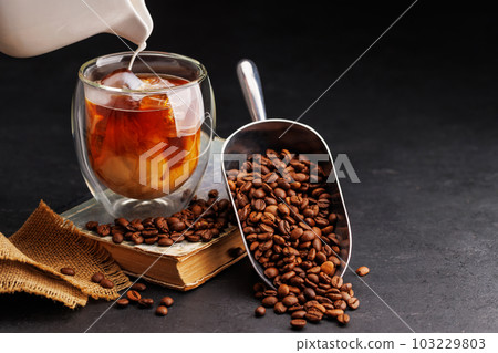 Iced cold brew coffee and freshly roasted coffee beans Iced cold brew coffee and freshly roasted coffee beans 103229803