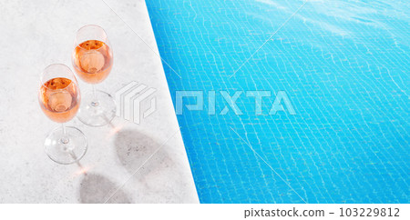 Refreshing rose wine by the pool on a sunny day 103229812