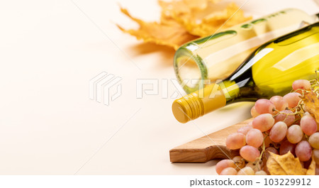 White wine bottles and autumn leaves 103229912