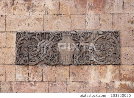 Ornate wall decoration with middle-east motives concept photo. Wase with fruits on the wall. Urban architectural photography. 103230030