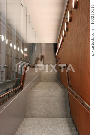 Stairs going down to the interior of a Warsaw underground passageconcept photo. Tunnel on Solidarity Avenue in Warsaw. Urban architectural photography. 103230116