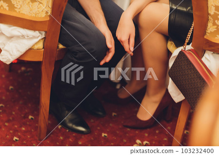close - up of a young woman's feet in red high-heeled genuine leather shoes. close - up of a young woman's feet in red high-heeled genuine leather shoes. 103232400