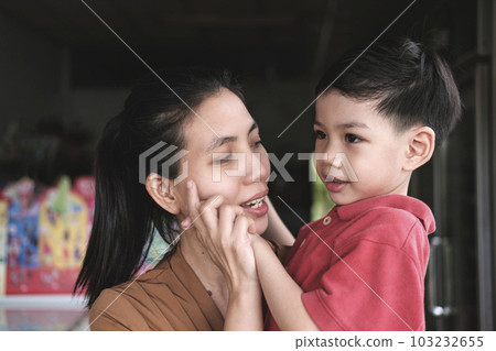Southeast Asian mother and son showing love for each other. 103232655