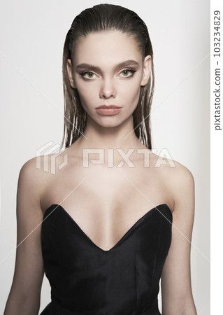 Beautiful woman pose in studio. Art portrait of a model in a bla 103234829