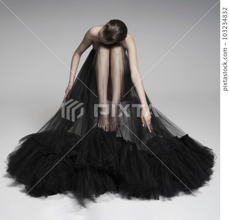 Beautiful woman pose in studio. Art portrait of a model in a bla Beautiful woman pose in studio. Art portrait of a model in a bla 103234832