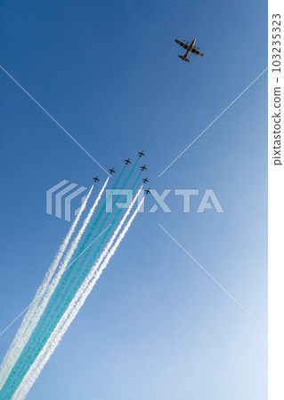Bomber leading fighter jets squadron with traces in Saudi Arabian national flag colors, at Jeddah air show Bomber leading fighter jets squadron with traces in Saudi Arabian national flag colors, at Jeddah air show 103235323