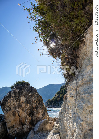 White rocks vertical cliff with greenery, Greece White rocks vertical cliff with greenery, Greece 103235976