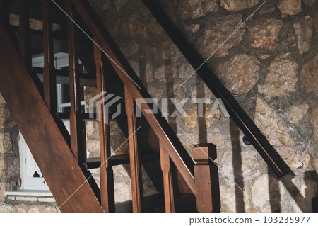Wooden stairs with stones wall in old Greek house Wooden stairs with stones wall in old Greek house 103235977