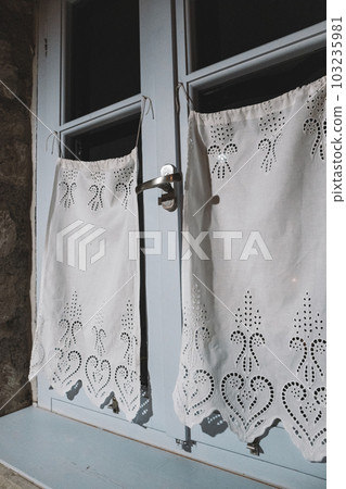Blue window with white curtains, interior close-up Blue window with white curtains, interior close-up 103235981