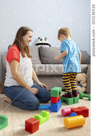 Happy loving family plays with plastic blocks and have fun. 103236538
