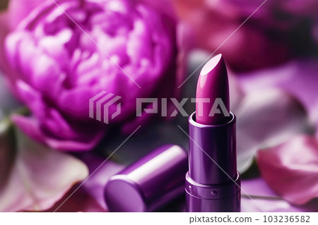 Professional makeup cosmetics, lipstick tube, purple background natural flowers. Beauty concept, decorative professional products 103236582