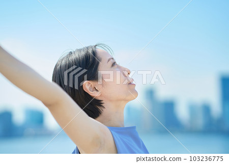 A woman with a relaxed expression under the blue sky 103236775