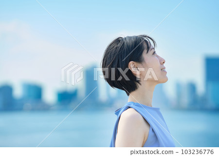 A woman with a relaxed expression under the blue sky 103236776