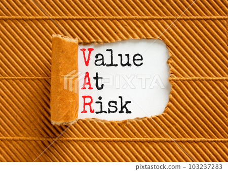 VAR Value at risk symbol. Concept words VAR Value at risk on beautiful white paper. Beautiful white table brown background. Business and VAR Value at risk concept. Copy space. 103237283