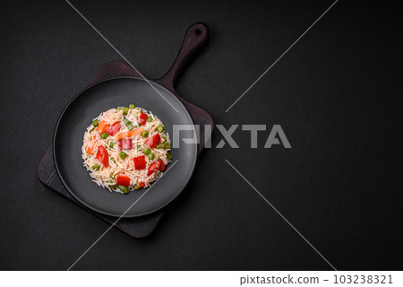Delicious boiled rice with peppers, peas, asparagus beans and carrots 103238321