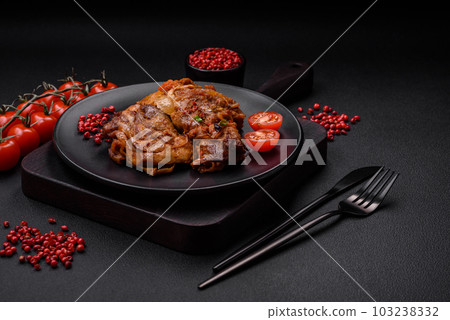 Delicious fried chicken in sauce with onions, salt, spices and herbs 103238332
