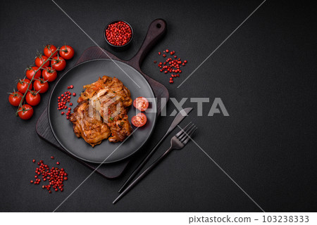 Delicious fried chicken in sauce with onions, salt, spices and herbs 103238333