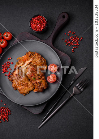 Delicious fried chicken in sauce with onions, salt, spices and herbs 103238334