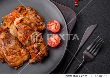 Delicious fried chicken in sauce with onions, salt, spices and herbs Delicious fried chicken in sauce with onions, salt, spices and herbs 103238335