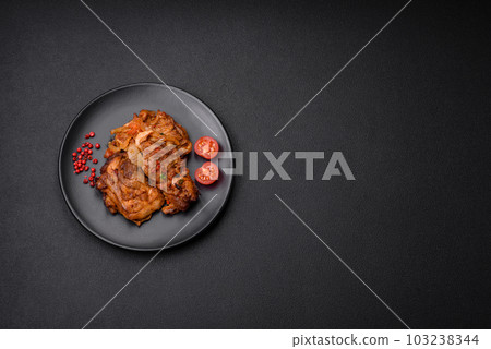 Delicious fried chicken in sauce with onions, salt, spices and herbs 103238344