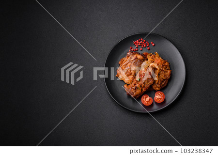 Delicious fried chicken in sauce with onions, salt, spices and herbs 103238347