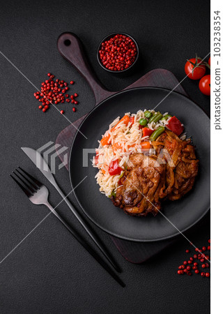 Delicious boiled rice with peppers, peas, asparagus beans and carrots and fried chicken Delicious boiled rice with peppers, peas, asparagus beans and carrots and fried chicken 103238354