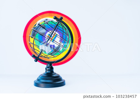 Metallic model of a globe with LGBT colorful rainbow background on the white. LGBTQIA Pride Month concept. Lesbian gay bisexual transgender. Gender equality. Human rights and tolerance. Copy space. 103238457