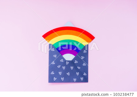 Rainbow in open paper envelope with hearts on the pink background. LGBT flag. LGBTQIA Pride Month concept. Lesbian gay bisexual transgender. Gender equality. Human rights and tolerance. Copy space. 103238477