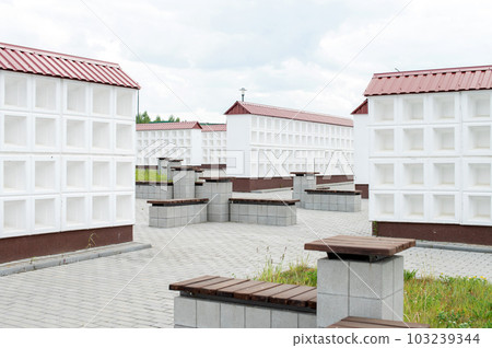 Rows of white walls for the burial of ashes after cremation. Empty boxes for urns Rows of white walls for the burial of ashes after cremation. Empty boxes for urns 103239344