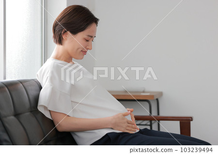 Pregnant woman 1 feeling the movement of the baby in her stomach Pregnant woman 1 feeling the movement of the baby in her stomach 103239494