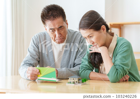 Senior couple troubled watching passbook 103240226