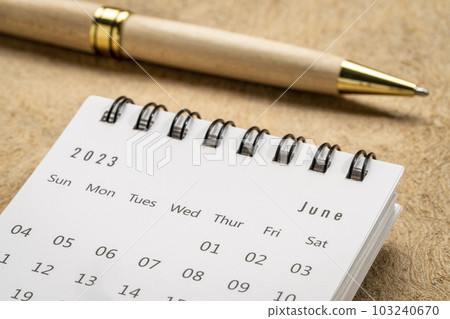 June 2023 - closeup of a small desktop calendar with a pen, time and business concept June 2023 - closeup of a small desktop calendar with a pen, time and business concept 103240670
